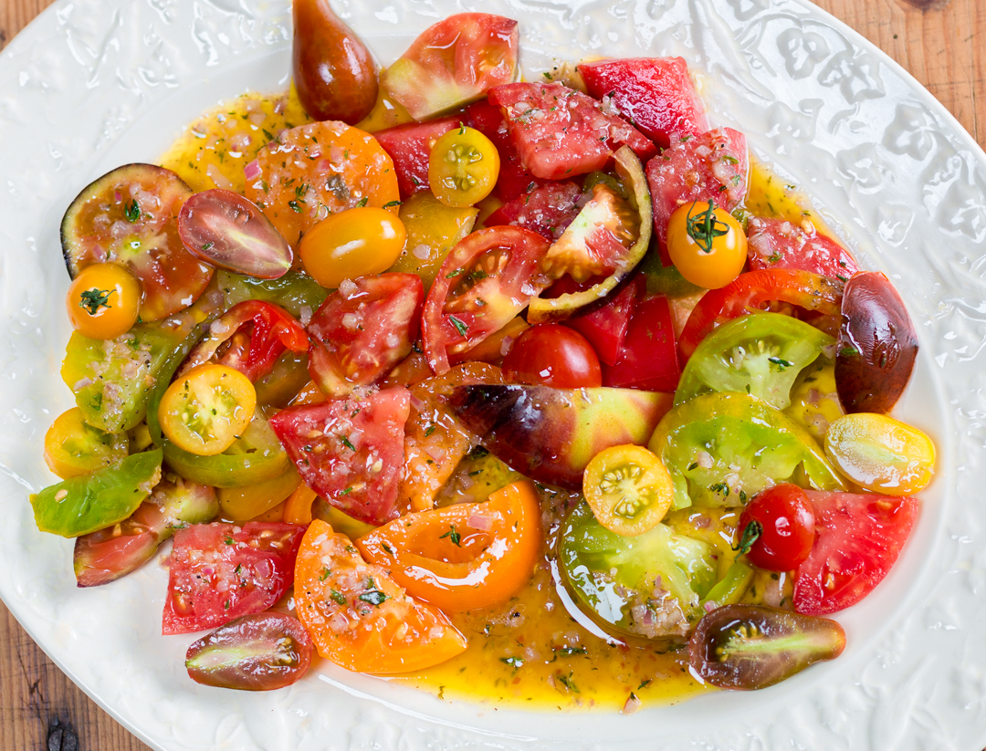 Marinate a colorful array of Heirloom Tomatoes in my Shallot-Thyme Vinaigrette