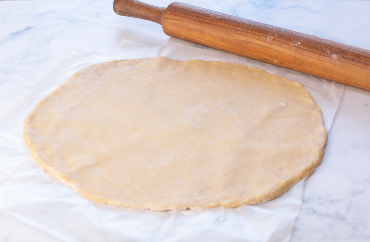Rolling Karen's Flaky Pie Dough into a 14" circle