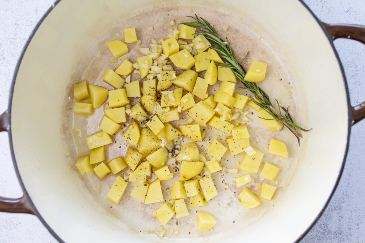 Cooking the potato cubes with rosemary