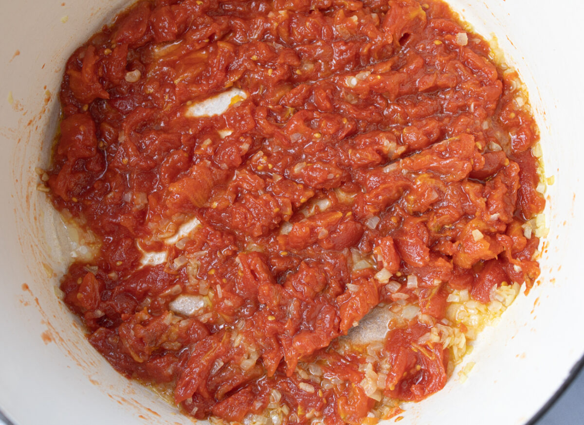Starting to cook the crust plum tomatoes