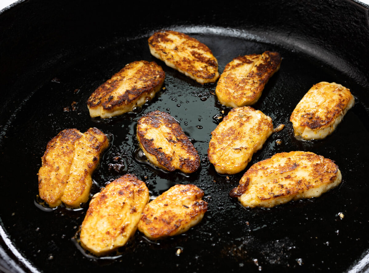 Grill sliced & spiced Halloumi in a cast iron skillet with a small amount of extra virgin olive oil
