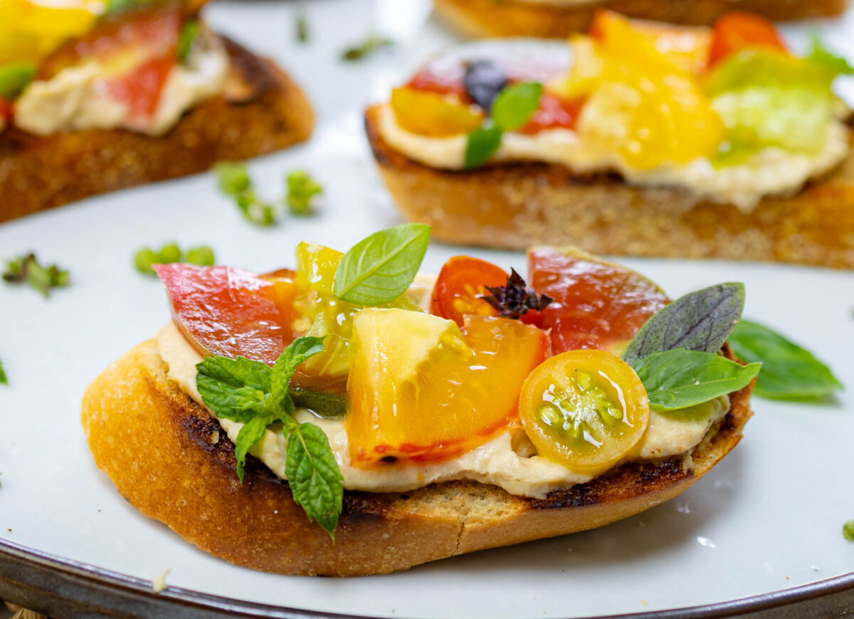 Quick & Delicious Heirloom Tomato Bruschetta with Hummus, Basil & Mint
