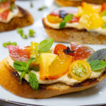 Quick & Delicious Heirloom Tomato Bruschetta with Hummus, Basil & Mint