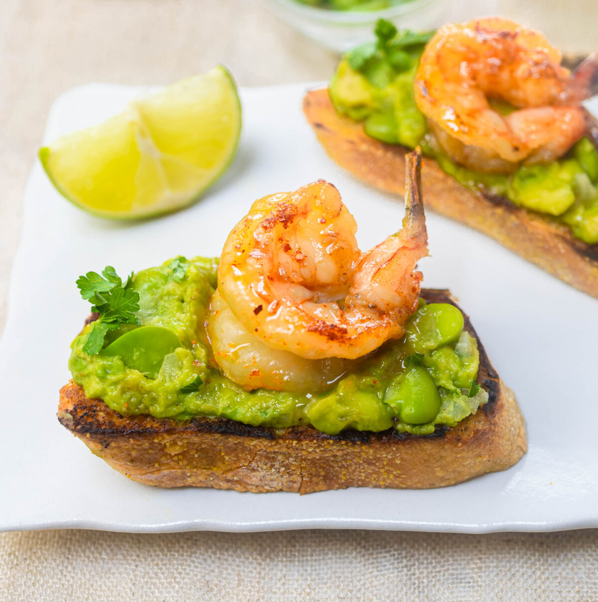 Smashed Avocado Bruschetta with Fava Beans and Honey Spiced Shrimp