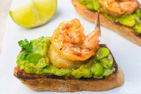 Smashed Avocado Bruschetta with Fava Beans and Honey Spiced Shrimp