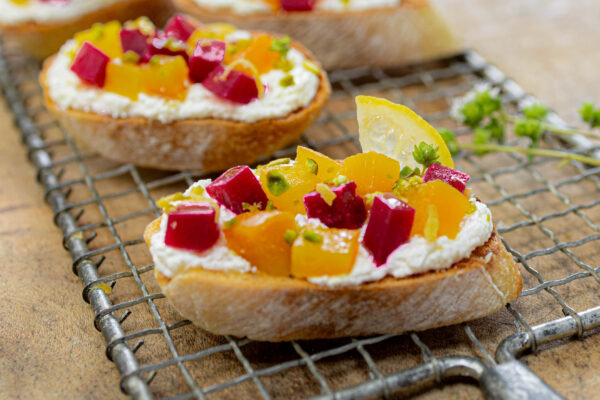 Roasted Golden and Ruby Beet Bruschetta over Whipped Lemon Feta with Pistachios