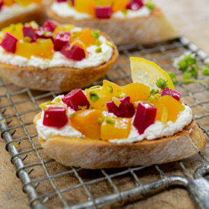 Roasted Golden and Ruby Beet Bruschetta over Whipped Lemon Feta with Pistachios